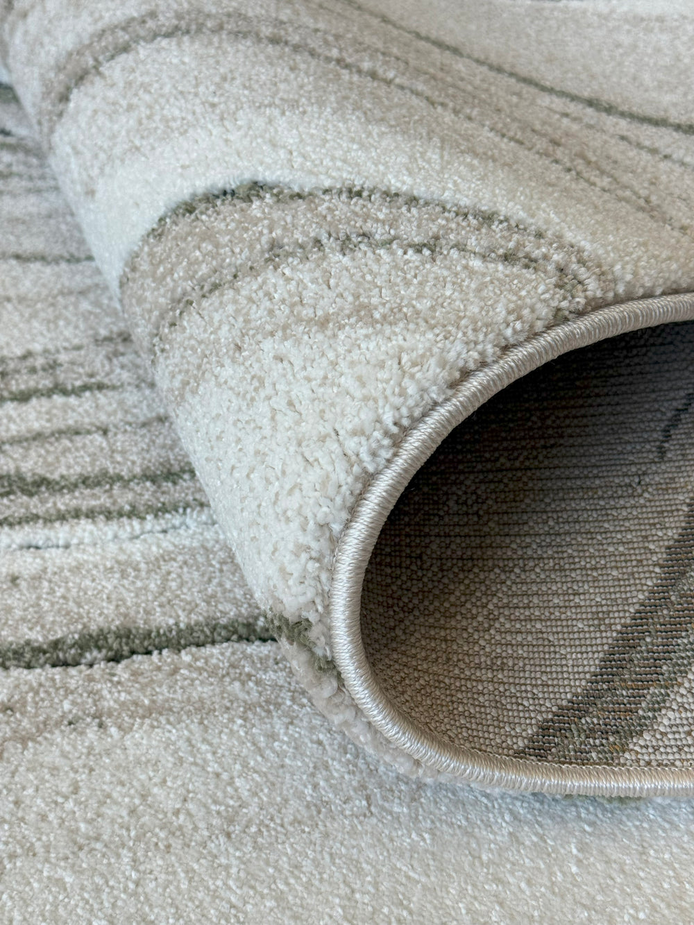 Modern plush rug with organic movement in taupe and olive green