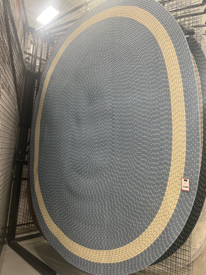 Oval braided rug in blue and cream