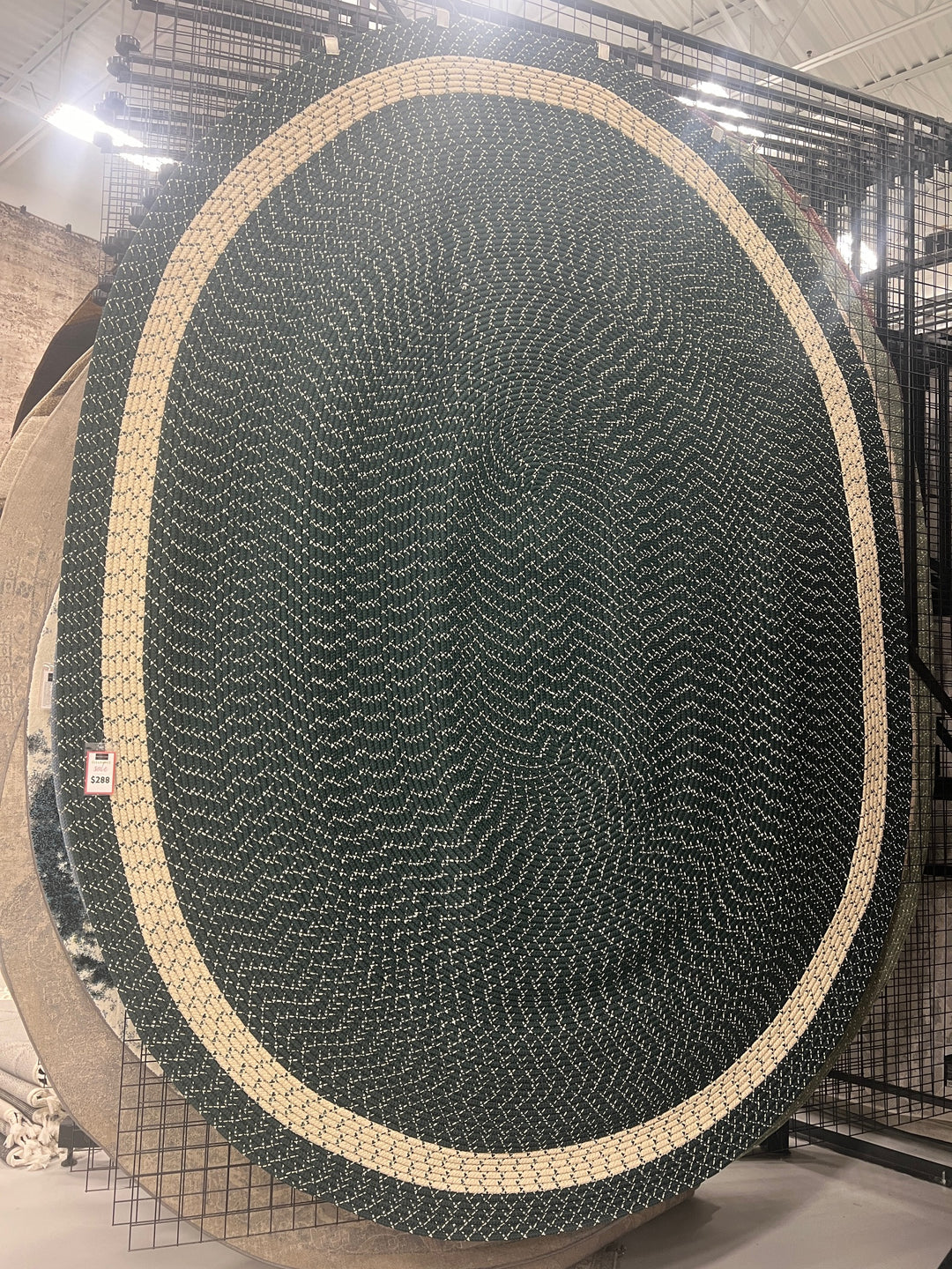 Oval braided rug in forest green with beige border, made of durable polypropylene