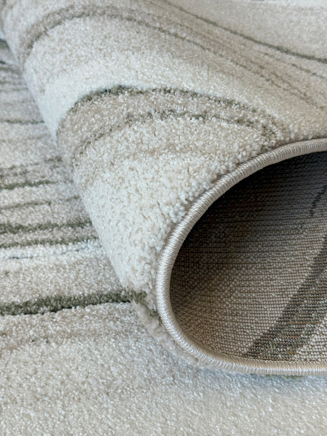 Modern plush rug with organic movement in taupe and olive green