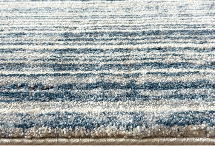 Modern soft area rug with coastal-inspired palette and linear texture