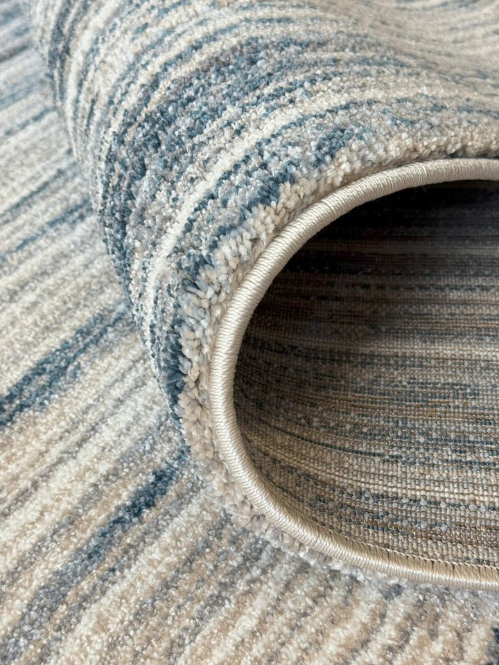 Neutral striped rug in beige and blue tones for living room or bedroom