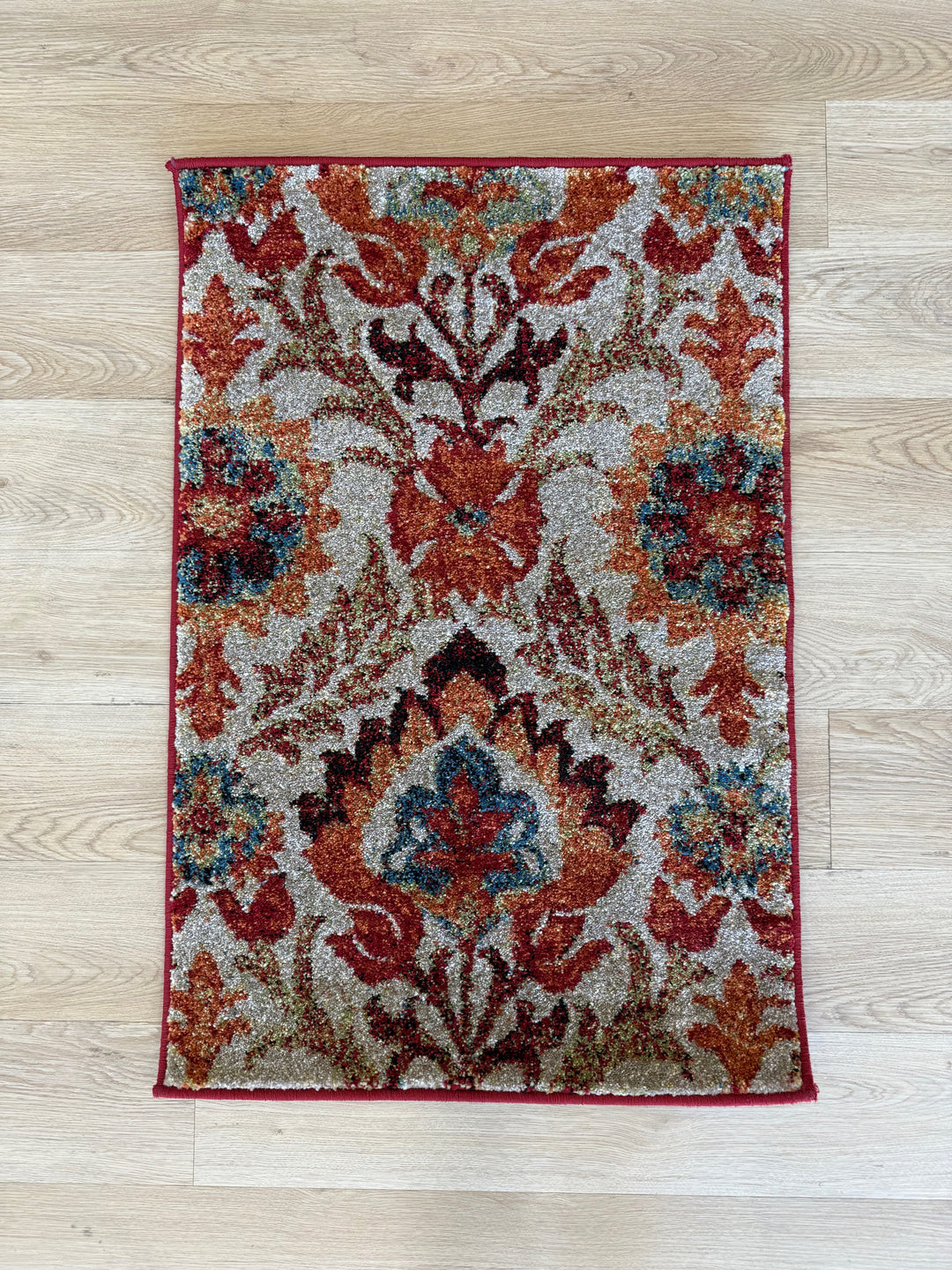 Southern bold rugs with red, teal, and taupe distressed floral pattern on textured polypropylene pile