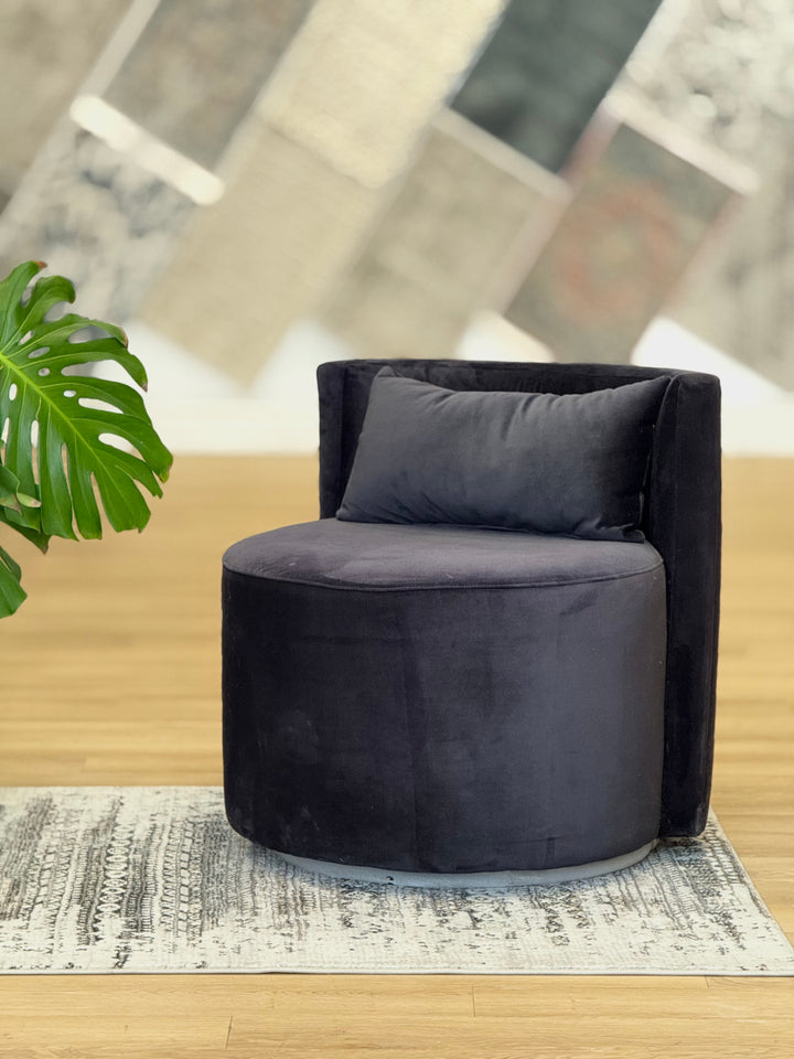 Black Audrey Swivel Chair upholstered in soft suede fabric, featuring a modern design with a 360-degree swivel base for added comfort and versatility.