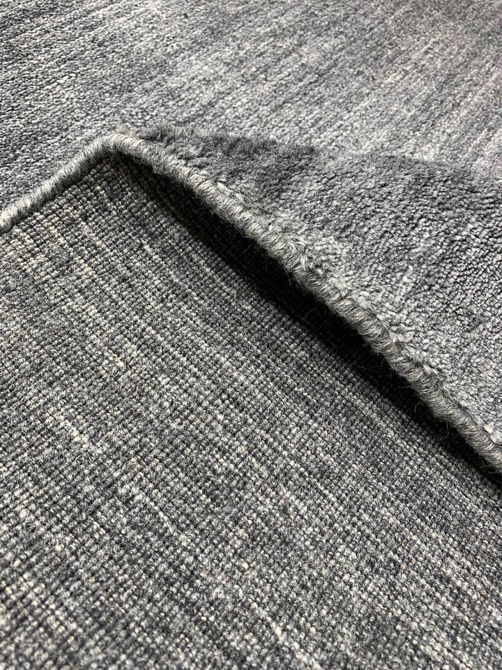 Akita Dark grey rug fold view horizontal texture