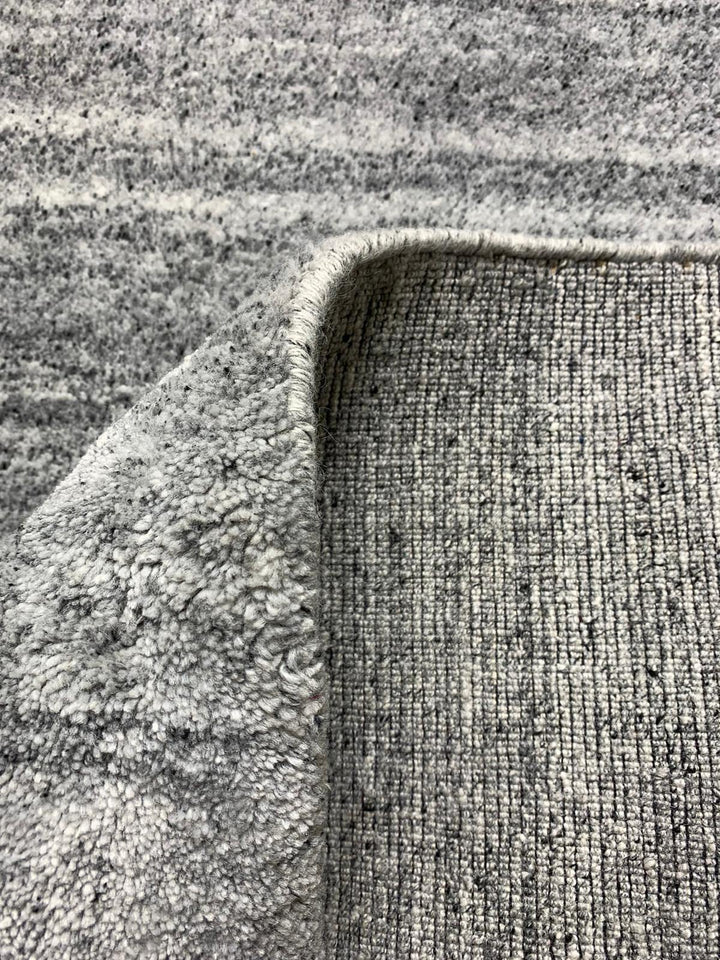 Akita Light Grey rug fold view light grey base dark grey flek horizontal texture