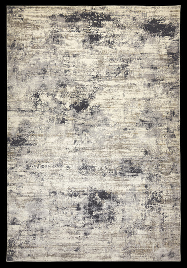 A modern abstract area rug with light grey and deep charcoal splatters on a cream/taupe background.