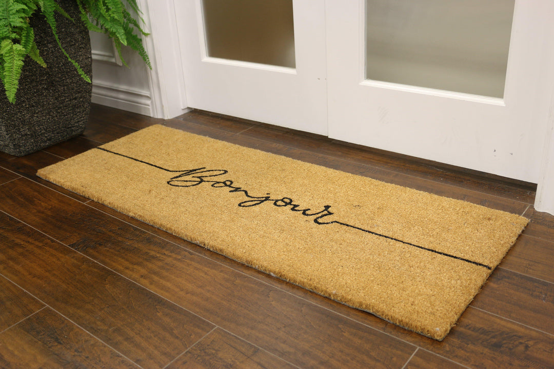 Coconut fibre welcome mat with "Bonjour" written in cursive 
