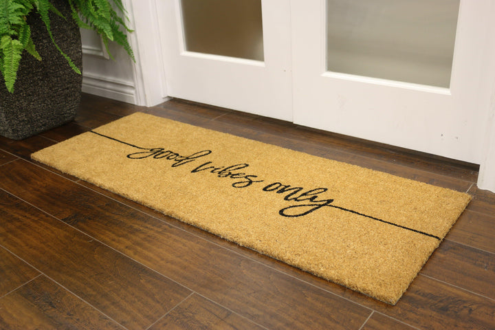Coconut fibre welcome mat with "good vibes only" written in cursive 
